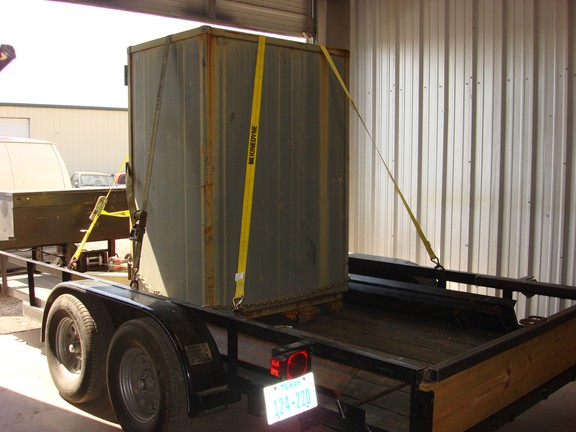 Large Mosler double door safe strapped on our safe moving trailer in our shop 2