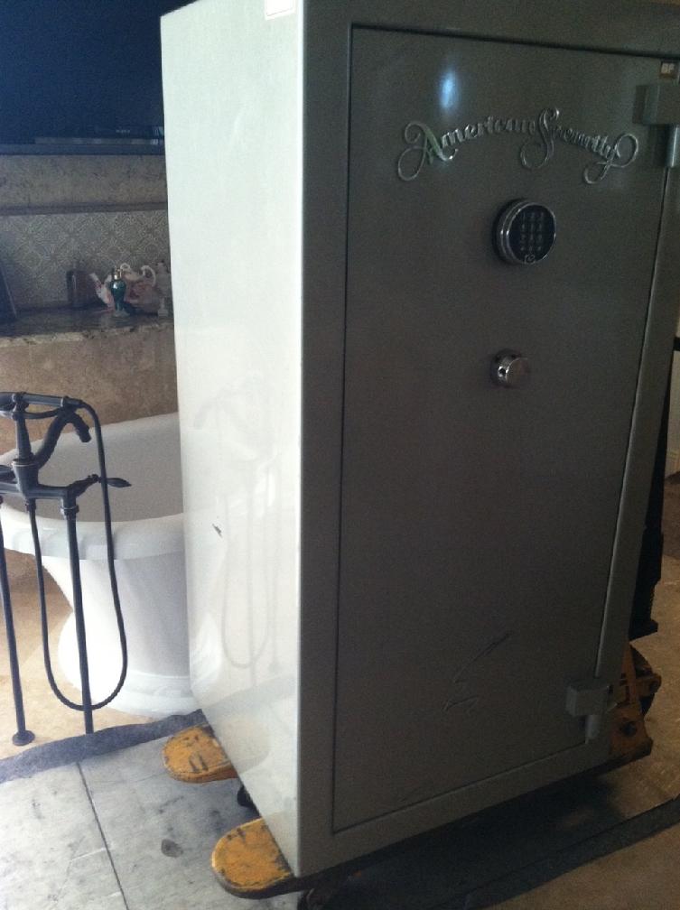 Amsec gun safe being moved through a bathroom 3