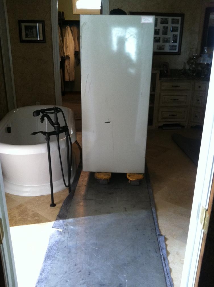 Amsec gun safe being moved through a bathroom 4