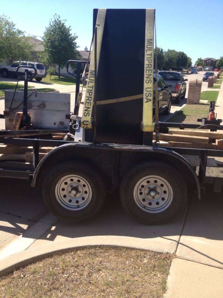 Safe moving trailer backed up in driveway ready to unload the gun safe